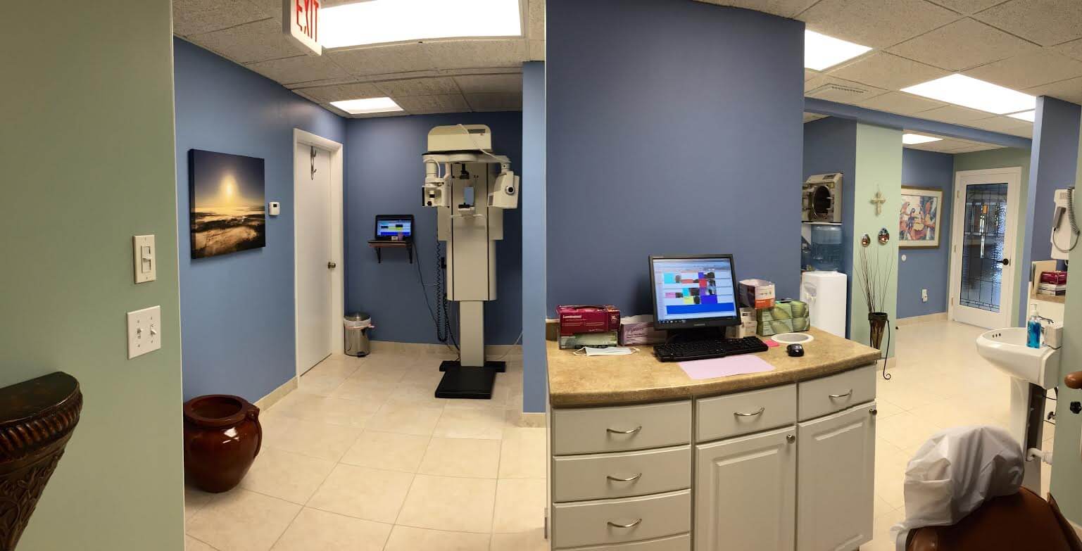 picture of the office showing the digital scanning machine and an examination room