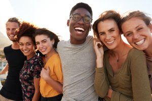 group of friends all proudly showing off their smiles.