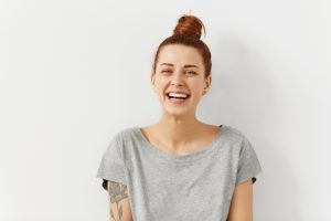 young woman smiling and showing off her smile