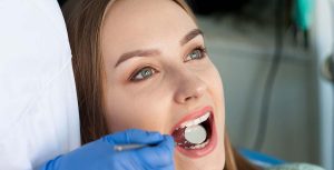 Young woman getting her teeth examined