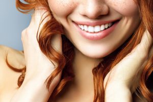 close up of a young woman's smile.