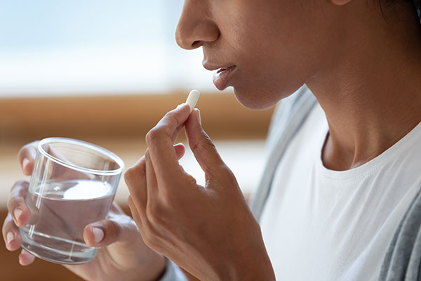 woman taking oral sedative medication