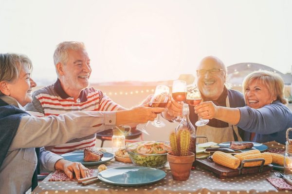 group of friends having dinner on the beach